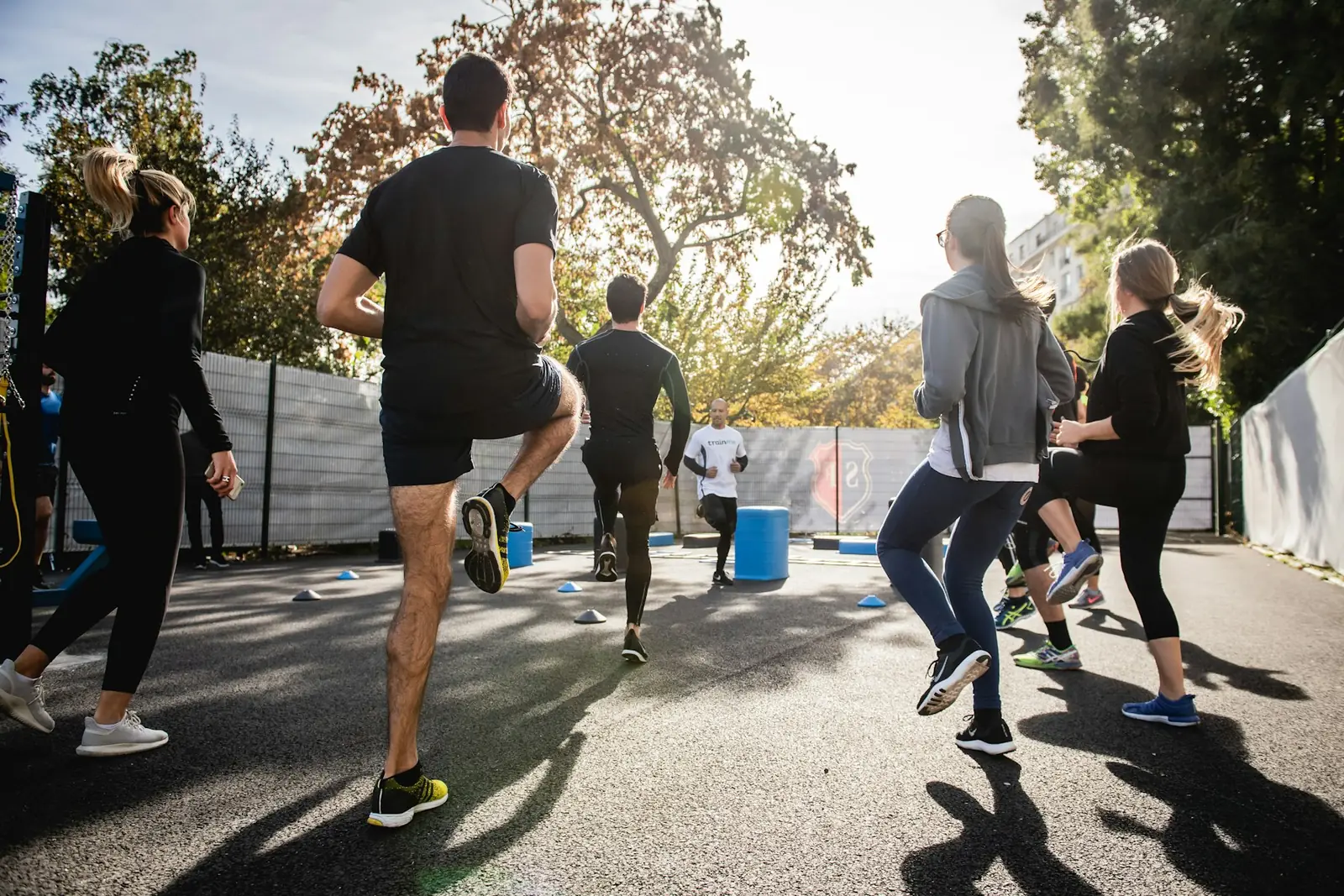 Outdoor bootcamp group running drills in morning light