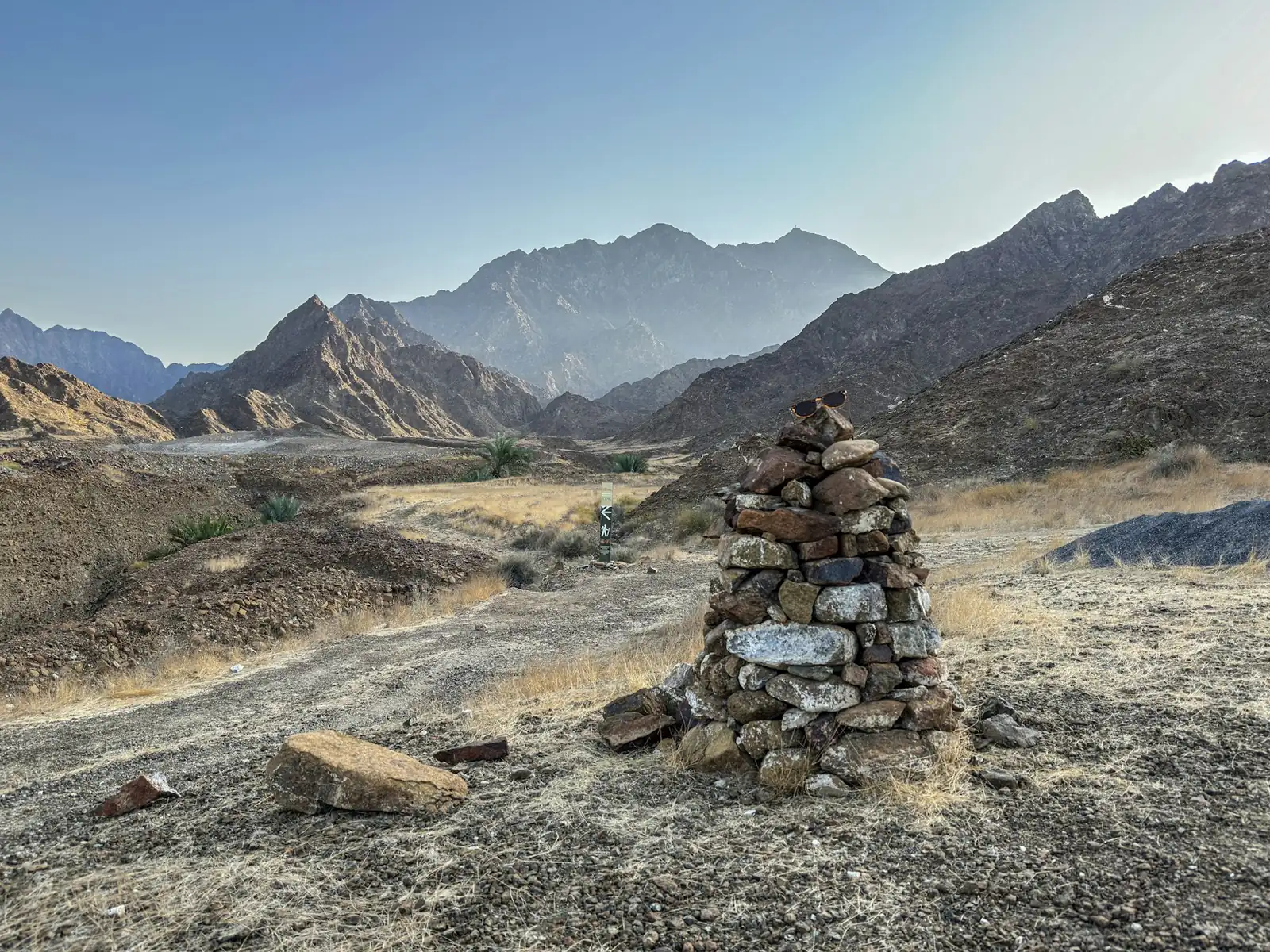 Stone cairn marking a path in a dry mountain valley