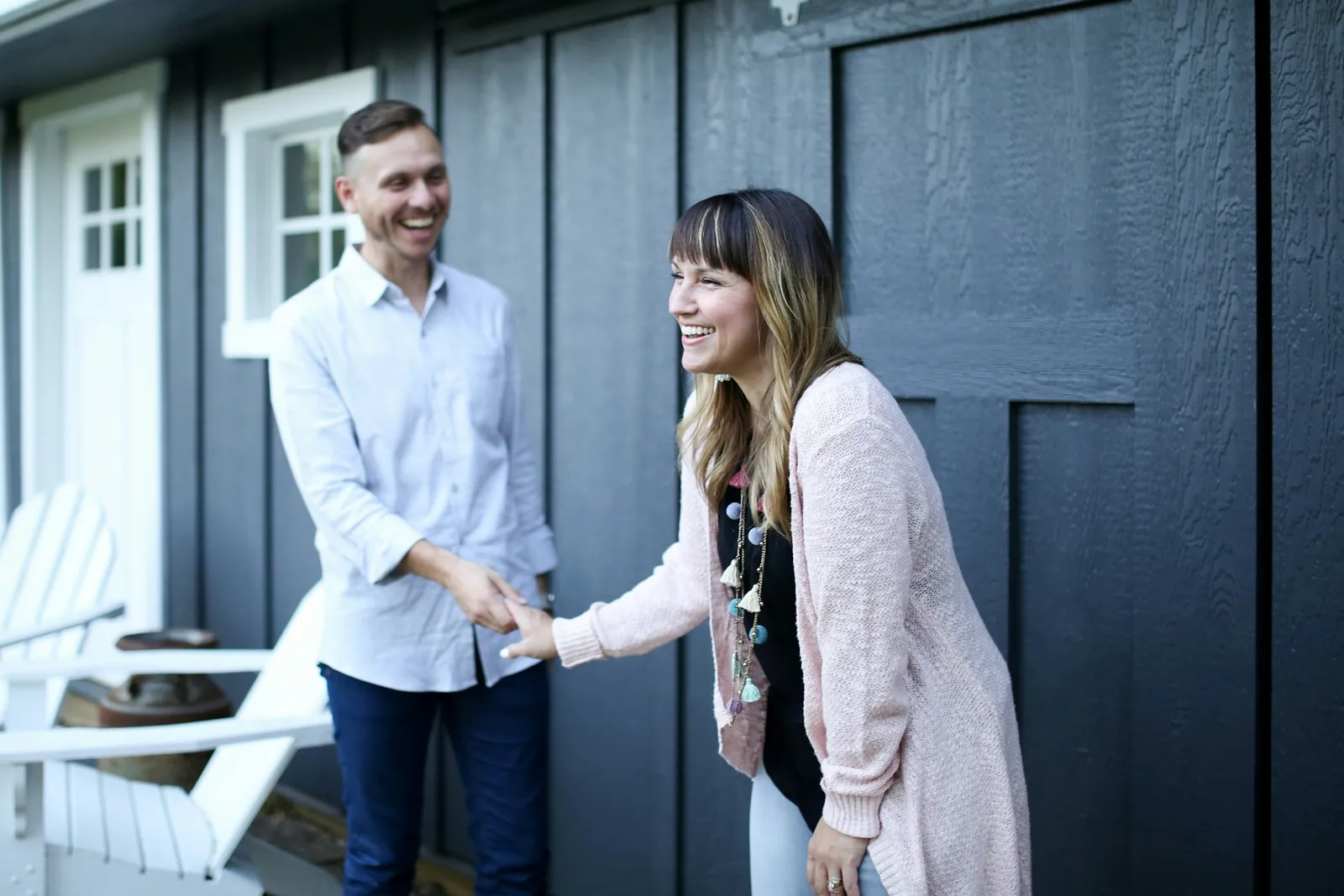 Two people greeting each other with a handshake at a front door
