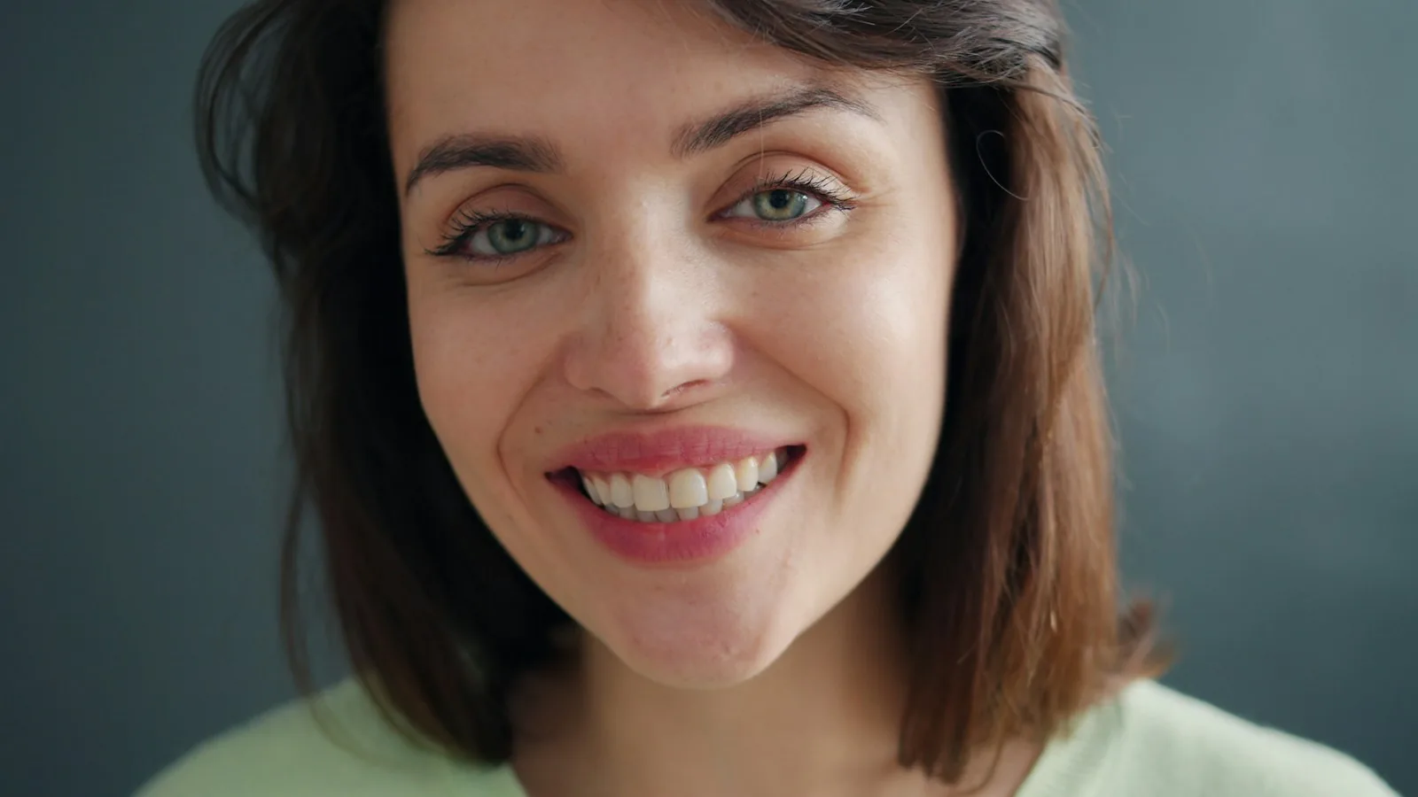Close portrait of a woman with a relaxed, natural smile
