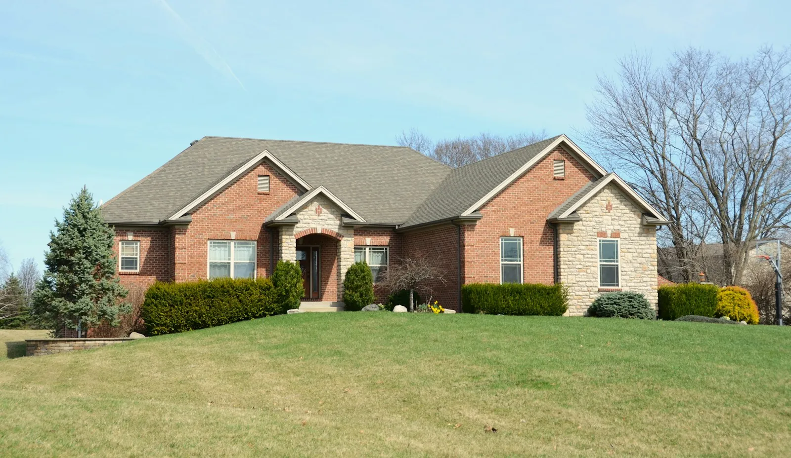 Before: brick house with a wide green lawn