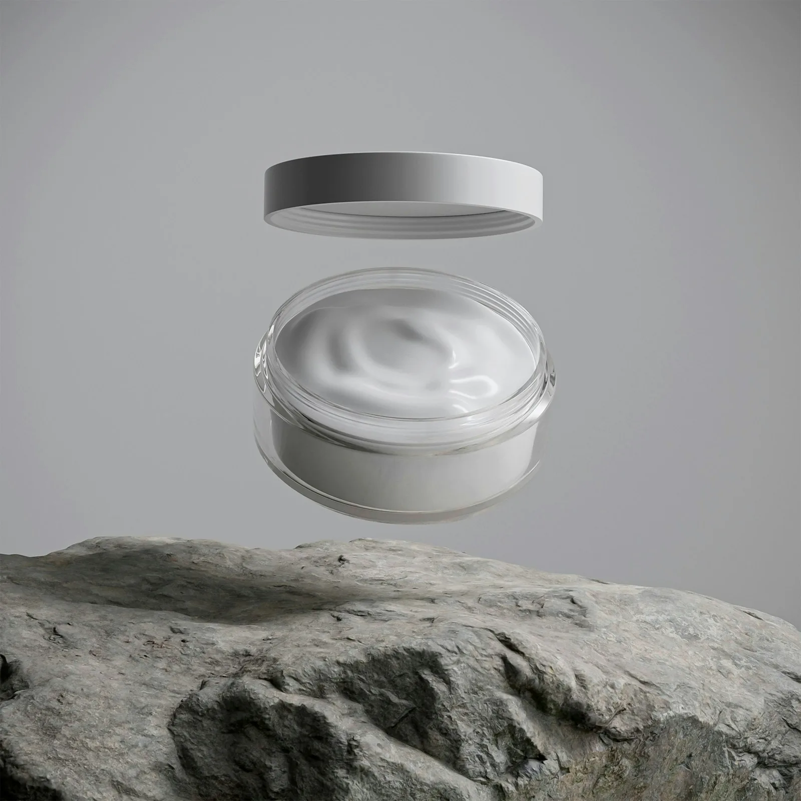 Open cream jar floating above a rough gray stone