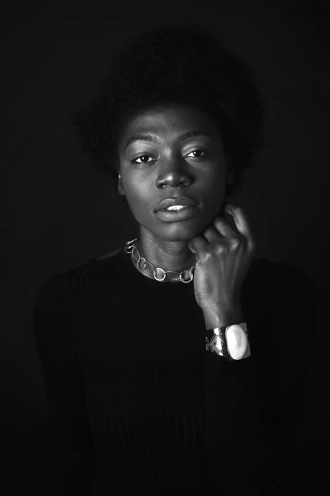 Black-and-white portrait of a woman in dark clothing