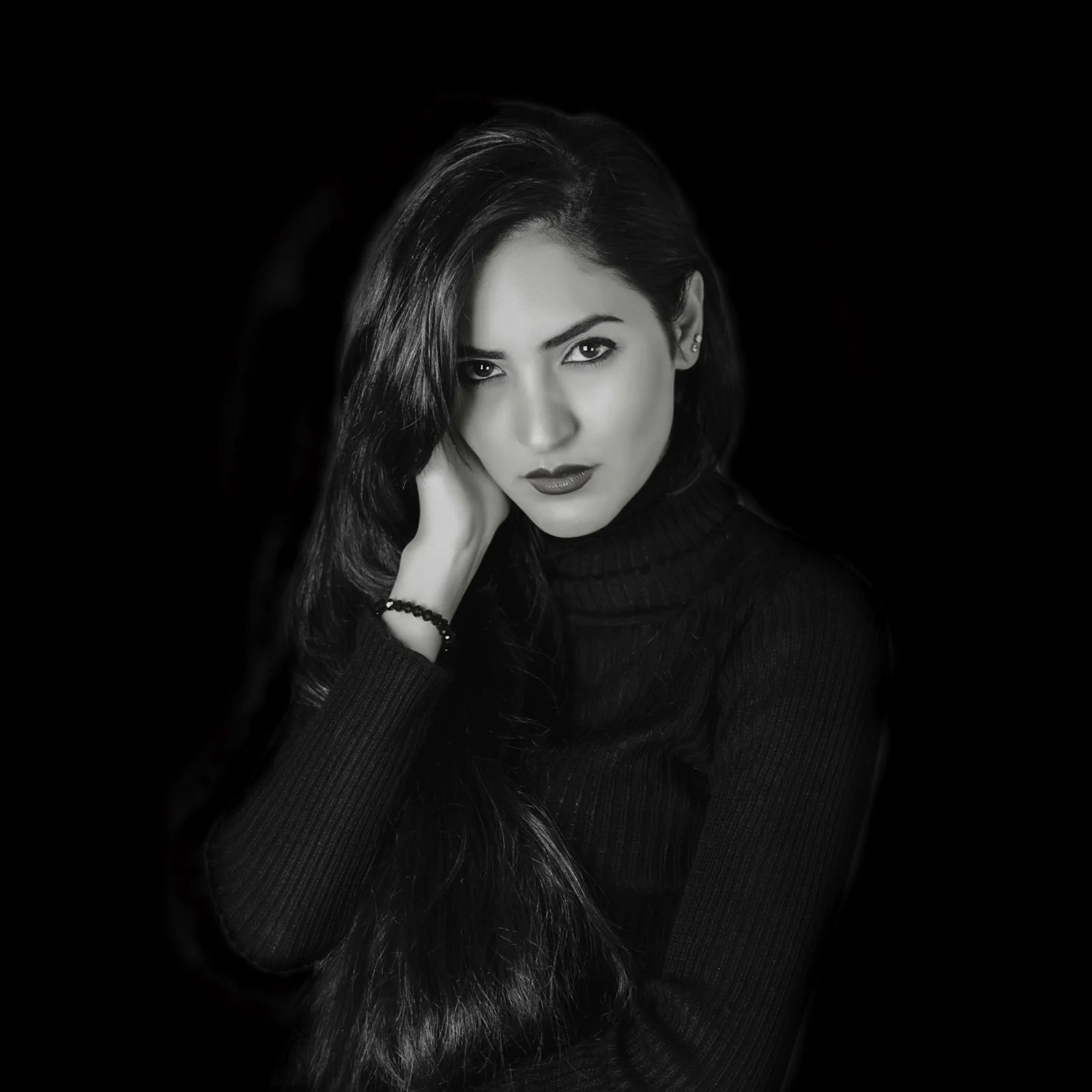 Black-and-white portrait of a woman in a dark turtleneck