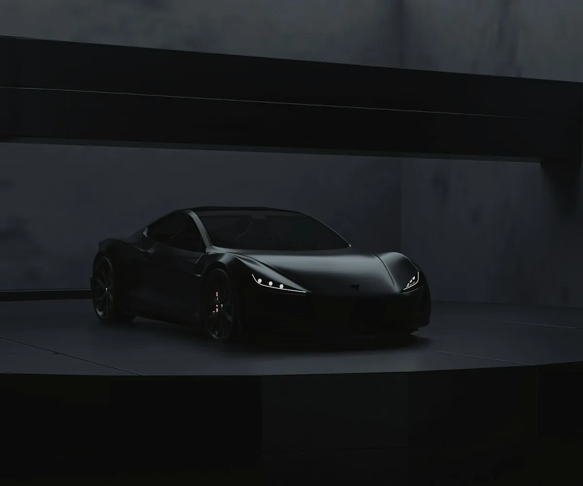 Dark sports car in a concrete studio bay under a long skylight