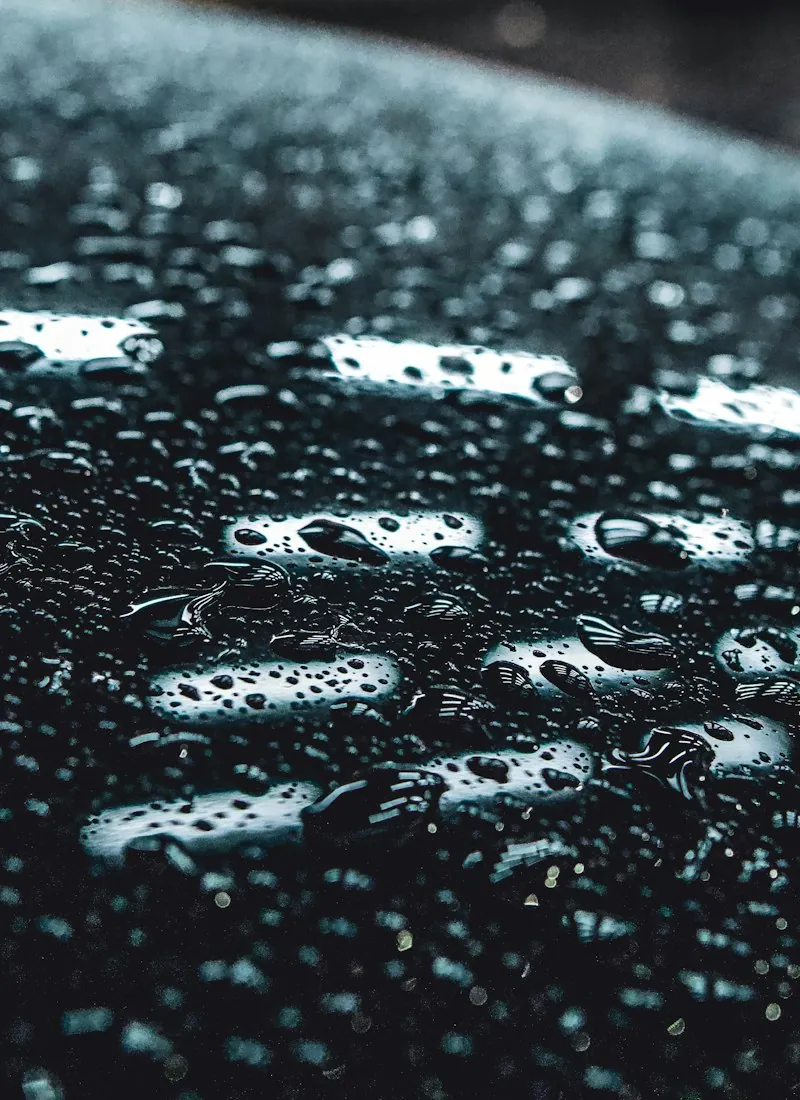 Water beading into tight droplets on ceramic-coated black paint