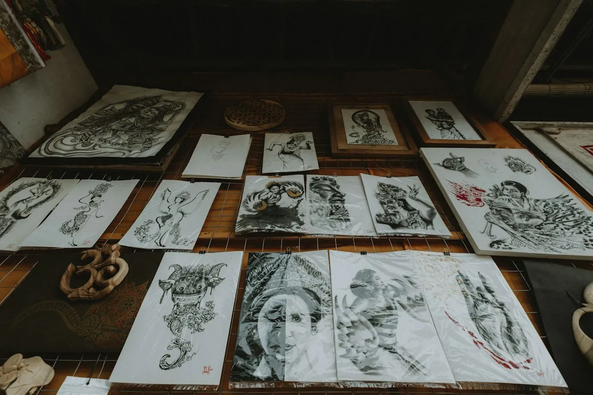 Rows of inked drawings pinned up across a wall